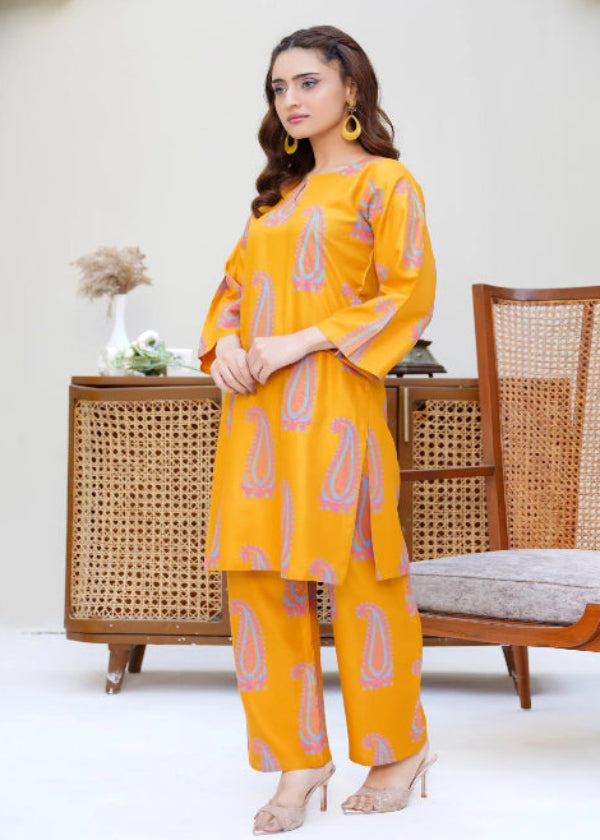 Woman in a yellow outfit standing in a room with wicker furniture.