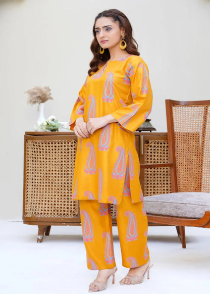 Woman in a yellow outfit standing in a room with wicker furniture.