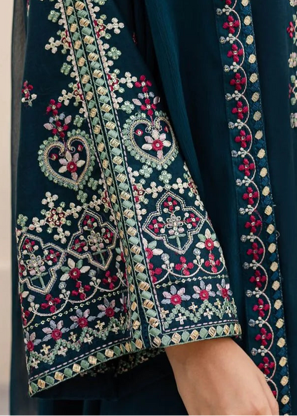 Navy blue embroidered traditional outfit with intricate patterns on a neutral background